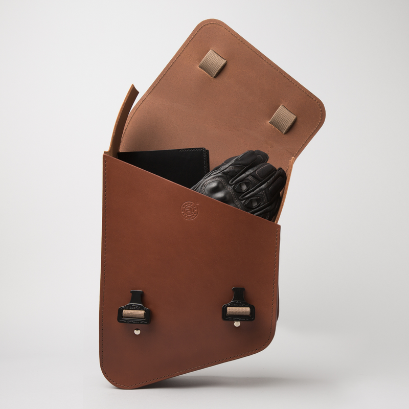 Adventurer II swingarm bag in tan leather. Opened bag with contents on view